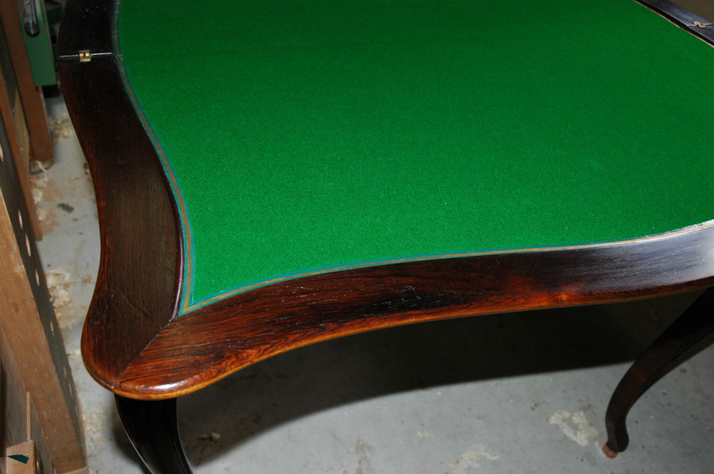 Baize and leather trim fixed