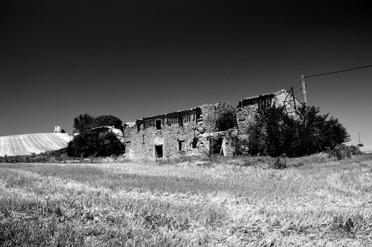 Abandoned farm house at the foot of the hill.